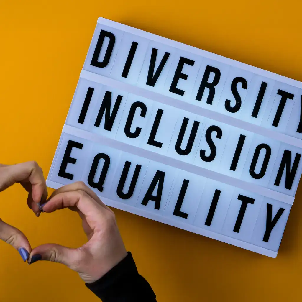 Hands making a heart by a diversity inclusion equality sign.