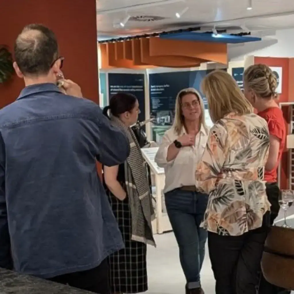 A group of people socialising at an indoor event.